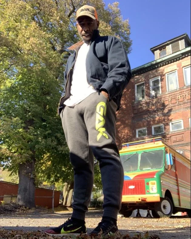 GAK joggers with neon logo worn on a Fitchburg street